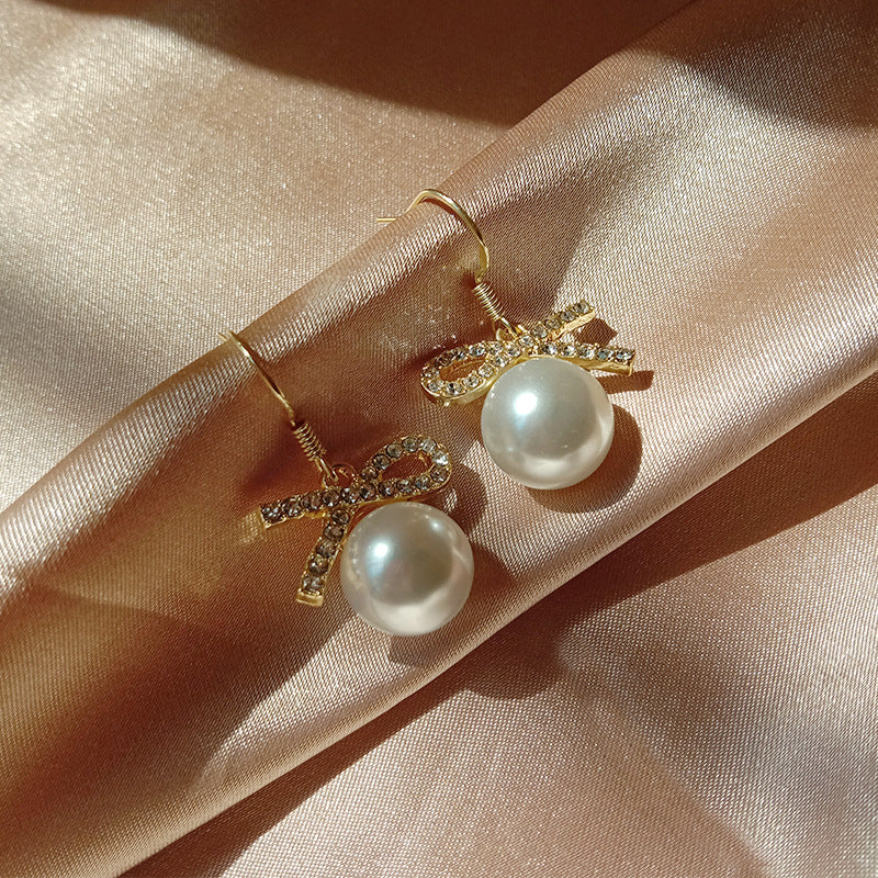 Fashionable earrings with diamond bows and pearls